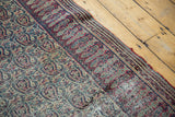 Antique Doroksh rug border with muted cochineal red, navy scrolling paisley, mostly even wear.
