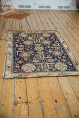 Detailed corner of an Antique Caucasian rug showing intricate geometric patterns and original worn fringe.