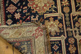 Folded edge of a circa 1910s antique Caucasian rug, exposing foundation, mostly even wear, and tattered split end.