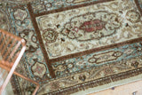 Vintage Tabriz rug's Rococo vinery, ivory, powder blue, dusty raspberry, and coffee brown.