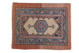 Antique Serab rug with a blue medallion, pomegranate motifs, and a wide camel hair border.