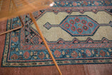 A collector's antique Serab rug, with its camel hair ground and blue pomegranate-filled medallion.