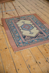 Angled view of an antique Serab collector rug showing its geometric design and flat weave.