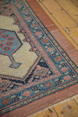 Intricate corner borders of an antique Serab rug, with its rare, wide raspberry outer stripe.