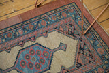 Corner view of an antique Serab rug highlighting its rare intact raspberry outer border.