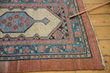 Corner of a collector Serab rug showing the camel hair field, medallion, and intact outer border.
