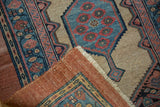 Folded corner of a late 19th-century Serab rug showing its hand-knotted texture and foundation.