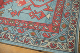 Oushak rug corner detail, madder red boteh border, primitive blossoms on faded denim blue field.