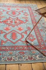 New Oushak rug showing repeating madder root red boteh border and faded denim field.