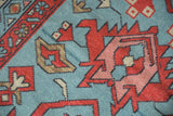 Geometric madder red and blush Samovar motifs on faded denim blue Oushak detail.