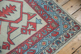 Hand-knotted Oushak rug corner with madder root red boteh and faded denim blue vine borders.
