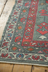 New Oushak rug's distinct madder red boteh and meandering vine pattern borders.