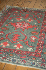 New Oushak rug detail: oxidized silver gray field, red palmette, and vine borders.