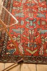 Cherry red Lilihan rug's curvilinear blue and gold floral patterns with soft patina.