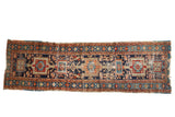 Antique Karaja runner with geometric medallions, navy, cherry red, and orange, showing mostly even wear and tatter.