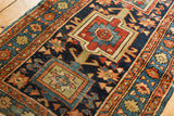 Hand-knotted antique Karaja runner with primitive geometric motifs in navy, burnt orange, and red.