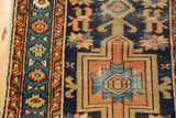 Late 19th-century Karaja runner detail: navy, orange, blue primitive geometric patterns, visible foundation.
