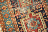 Antique Karaja runner: primitive geometric motifs in navy, red, blue, showing foundation wear.