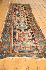 Worn pile revealing foundation and tattered fringe on antique Karaja runner end.