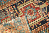 Folded antique Karaja rug edge revealing hand-knotted foundation and worn geometric pattern.