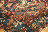 Worn hand-knotted pile of a vintage Baktiari rug, featuring rich red, navy, and ivory tribal motifs.