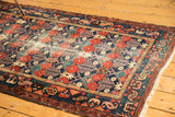 Vintage Baktiari rug corner detail, intricate borders, navy, red, ivory field, tattered fringe.