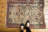 Antique Shirvan rug corner showing scarce ivory ground, geometric pawn border, and worn fringe.