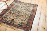 Antique Shirvan rug: aged ivory field, oversized medallions, and pawn border detail.
