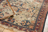 Antique Shirvan rug's ivory field, red and blue reciprocating pawn border, visible wear.