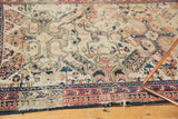 Worn geometric reciprocating pawn border in blue, red, ivory on antique Shirvan rug.