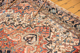 Hand-knotted Heriz rug featuring detailed brick red, blue, and ivory geometric patterns.