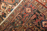 Vintage Heriz carpet showing hand-knotted foundation, secured side, and geometric corner pattern.