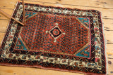 Vintage Persian Engelas mat showing its rich low-pile texture and saturated gem tones.
