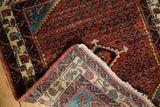 Folded corner of a vintage Engelas rug reveals the detailed hand-knotted back and low pile.