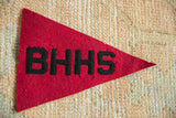 Vintage BHHS felt pennant close-up, black lettering on red with aged texture.