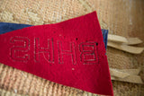 Vintage red felt BHHS pennant with black stitched lettering and cream ties.