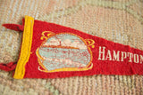 Aged red felt Hampton Beach pennant with cracked coastal scene and yellow trim.