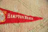 Vintage Hampton Beach felt pennant with white lettering, aged red felt, and frayed tip.