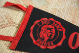 Red felt border with vintage handwriting and Warrior emblem on the YMCA pennant.