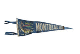 Vintage blue felt Montreal, Quebec pennant with a fish illustration and white lettering.