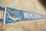 Close-up on the vintage Montreal pennant's fish graphic and time-worn lettering.