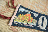 Close-up of the cracked, colorful graphic on the vintage Chateau Frontenac felt pennant.