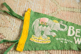 Green felt pennant detail with grey elephant, pink saddle, yellow platform, green ties.