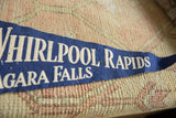 Textured blue felt and crisp white block lettering on the vintage souvenir pennant.