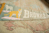 Cracked orange tiger and white lettering on an oxidized green vintage Bronx Zoo felt pennant.