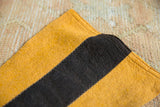Felt pennant detail, zig-zag stitching joining yellow and black felt pieces.