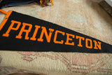 Raised orange PRINCETON lettering on vintage black felt pennant.