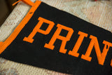 Black felt vintage Princeton pennant, orange 'PRIN' lettering with subtle wear.