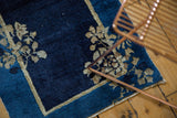 Antique Peking runner corner, indigo blue field, beige floral sprays, double border.