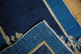 Antique Peking rug with indigo foundation, scattered white knots, and secured side.